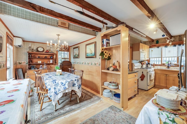 dining space with sink, light hardwood / wood-style floors, a wall mounted AC, and a notable chandelier