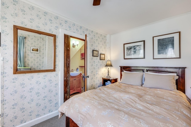 carpeted bedroom featuring crown molding, sink, ensuite bathroom, and ceiling fan