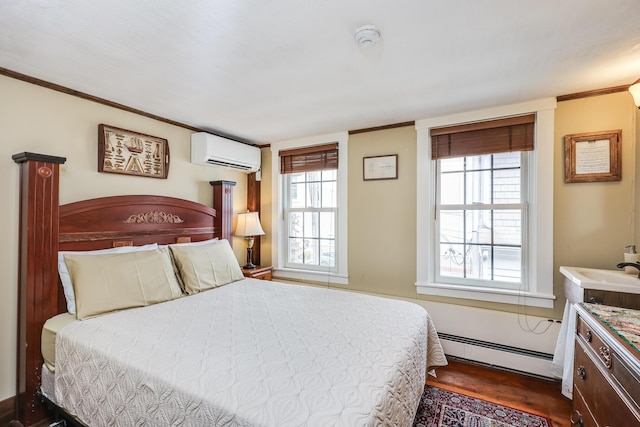 bedroom featuring dark wood-type flooring, a baseboard heating unit, and a wall mounted AC