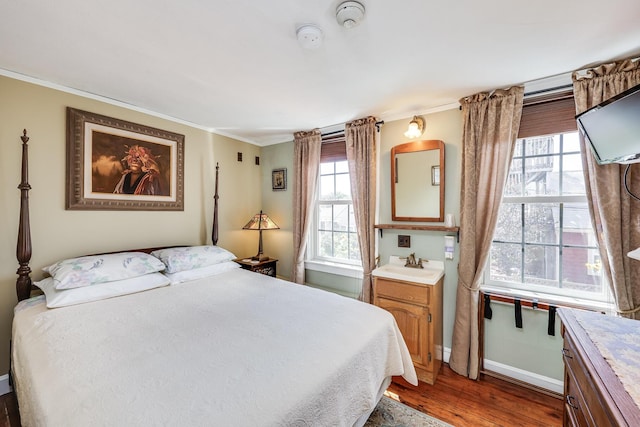 bedroom featuring dark wood-type flooring and crown molding