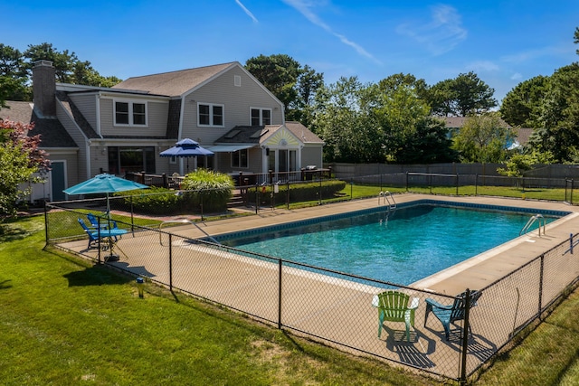 view of pool with a yard