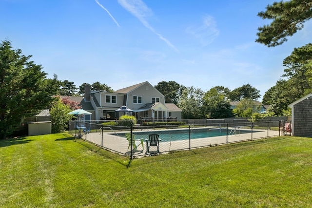 view of pool featuring a lawn