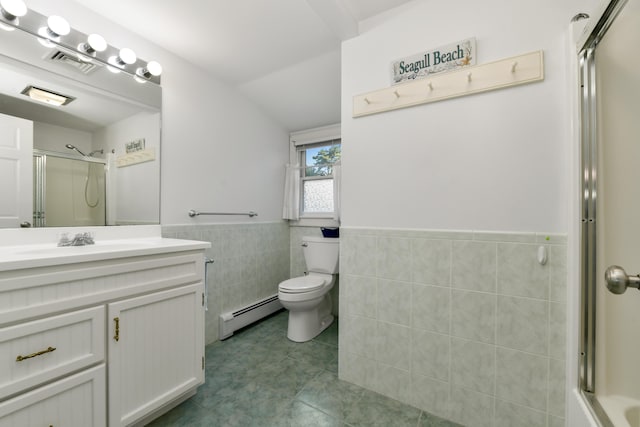 bathroom with a shower with door, a baseboard heating unit, tile walls, toilet, and vanity