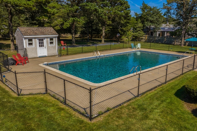 view of swimming pool with a lawn and an outdoor structure