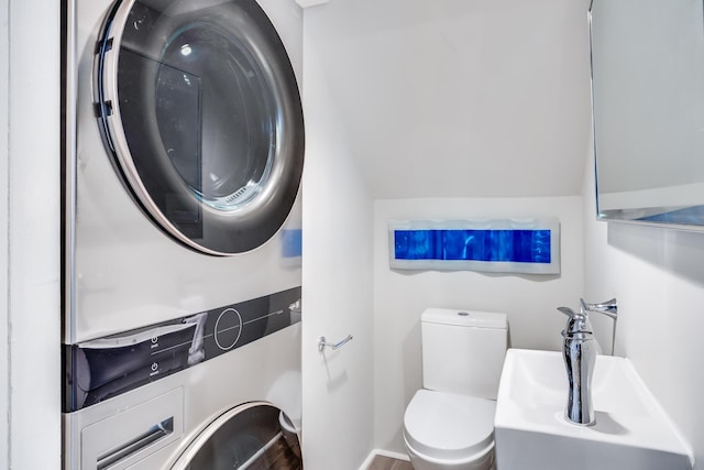 165 Commercial St Unit 4, Provincetown, MA 02657 - bathroom featuring stacked washer / dryer and toilet
