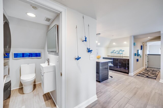 165 Commercial St Unit 4, Provincetown, MA 02657 - full bathroom with vanity, wood finished floors, and vaulted ceiling