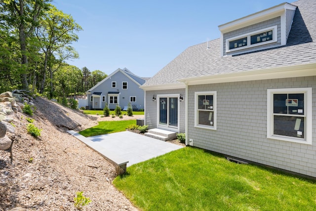 rear view of property featuring a patio area and a yard