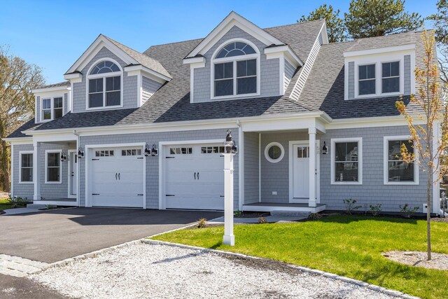 213 N Falmouth Hwy Unit 5A, North Falmouth, MA 02556 - view of front of property with an attached garage, driveway, a shingled roof, and a front yard