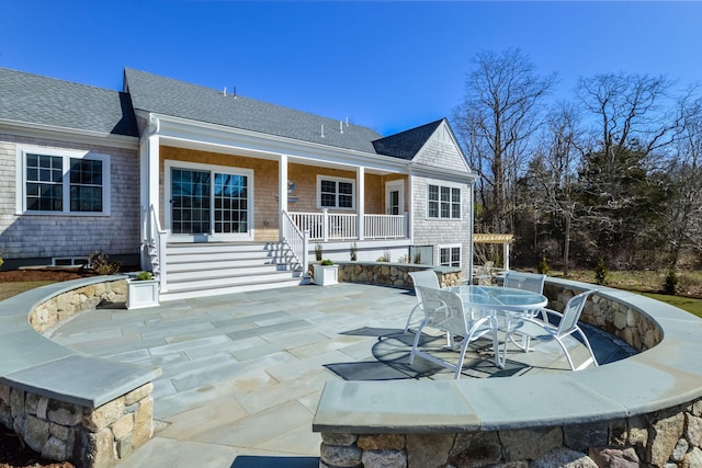 back of house featuring a shingled roof and a patio