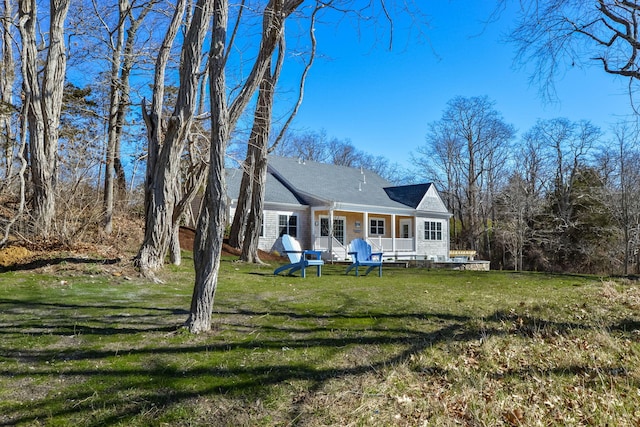 back of property featuring a yard