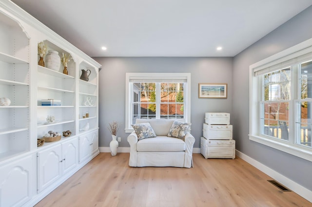 sitting room featuring baseboards, recessed lighting, and light wood-style floors