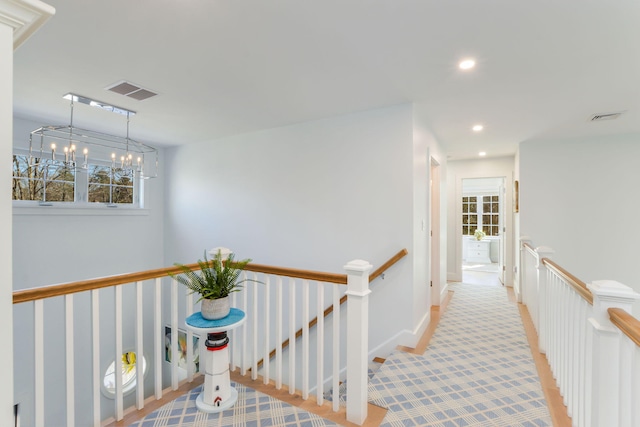 hall featuring visible vents, carpet, an upstairs landing, and recessed lighting