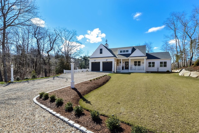modern farmhouse with a front lawn, driveway, an attached garage, and a porch