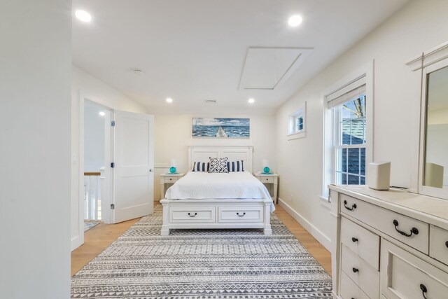 bedroom with attic access, baseboards, light wood-style floors, and recessed lighting