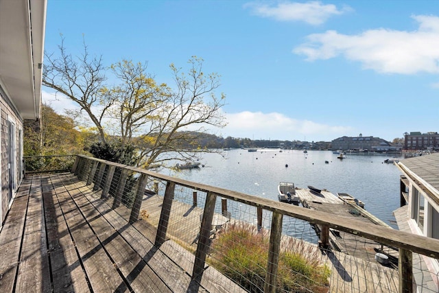 wooden terrace featuring a water view