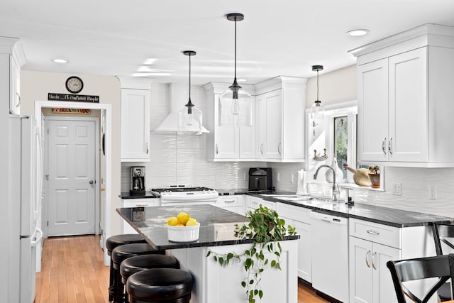39 Fox Run Ln, East Falmouth, MA 02536 - kitchen featuring white appliances, a sink, a breakfast bar, white cabinetry, and recessed lighting
