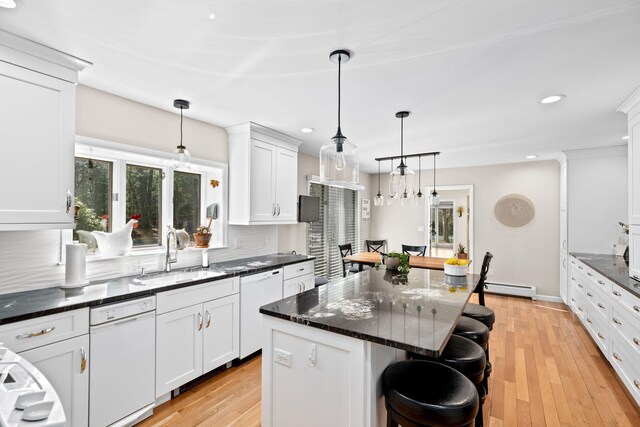 39 Fox Run Ln, East Falmouth, MA 02536 - kitchen with a sink, baseboard heating, white dishwasher, a kitchen breakfast bar, and recessed lighting