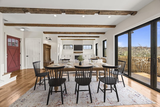 dining area with light wood-type flooring, beamed ceiling, and recessed lighting