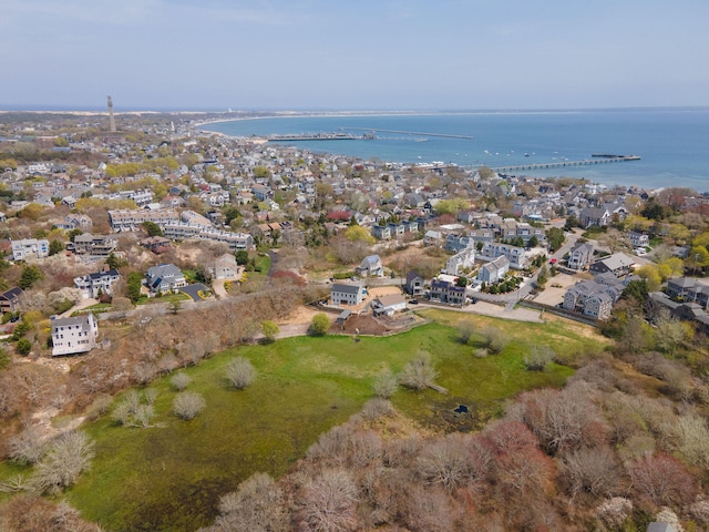 aerial view of property's location with a large body of water and nearby suburban area
