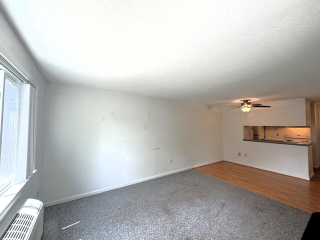 101 Fletcher Ln Unit K, Brewster, MA 02631 - carpeted empty room with healthy amount of natural light, ceiling fan, baseboards, and a textured ceiling