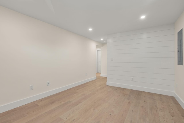 unfurnished room featuring light wood-type flooring, baseboards, and recessed lighting