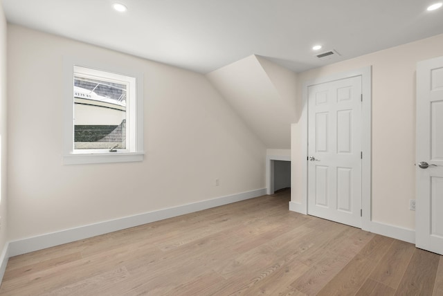 additional living space featuring light wood finished floors, recessed lighting, and baseboards