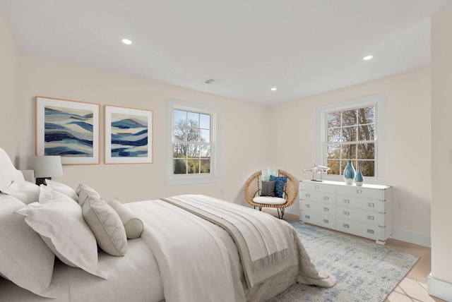 bedroom featuring visible vents, baseboards, wood finished floors, and recessed lighting