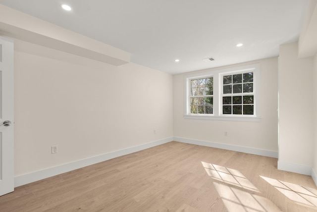 spare room featuring baseboards, recessed lighting, and light wood-style floors