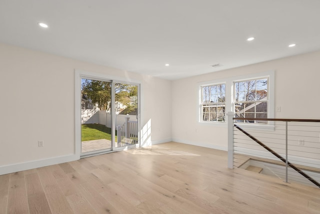 spare room with light wood-type flooring, visible vents, baseboards, and recessed lighting