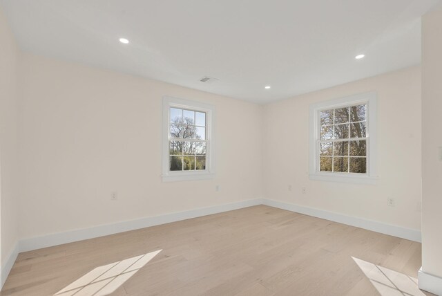 spare room with baseboards, recessed lighting, visible vents, and light wood-style floors