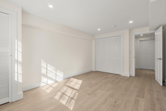 unfurnished bedroom with light wood-style floors, baseboards, a closet, and recessed lighting