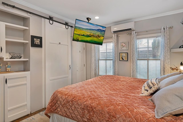 bedroom with a barn door, a wall mounted AC, and ornamental molding