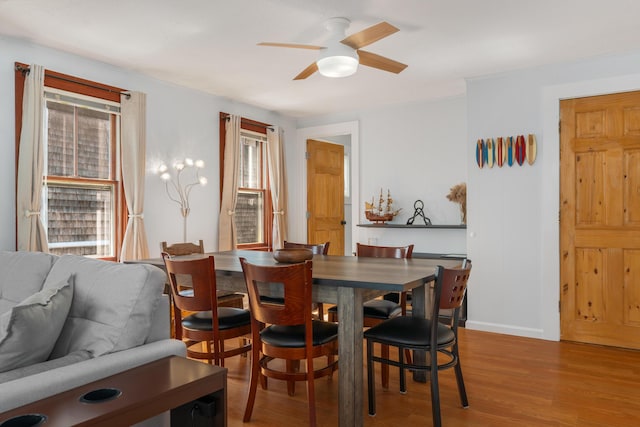 dining area with hardwood / wood-style flooring, a healthy amount of sunlight, and ceiling fan