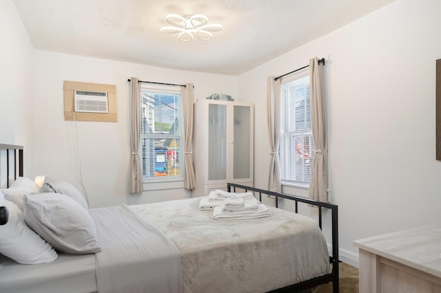 bedroom featuring an AC wall unit