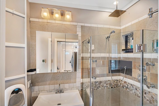 bathroom featuring sink and a shower with door