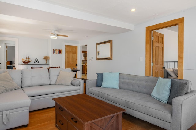 living room with hardwood / wood-style flooring and ceiling fan