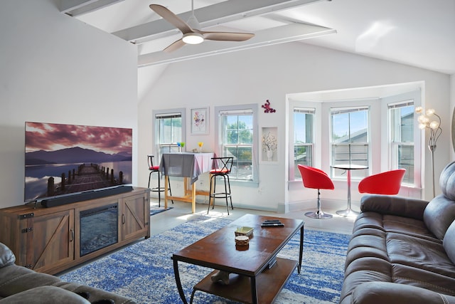 living room with ceiling fan and vaulted ceiling with beams