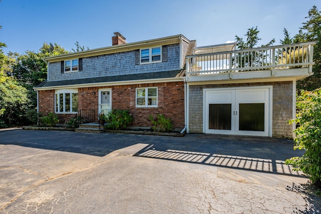 view of front of property featuring a balcony and french doors