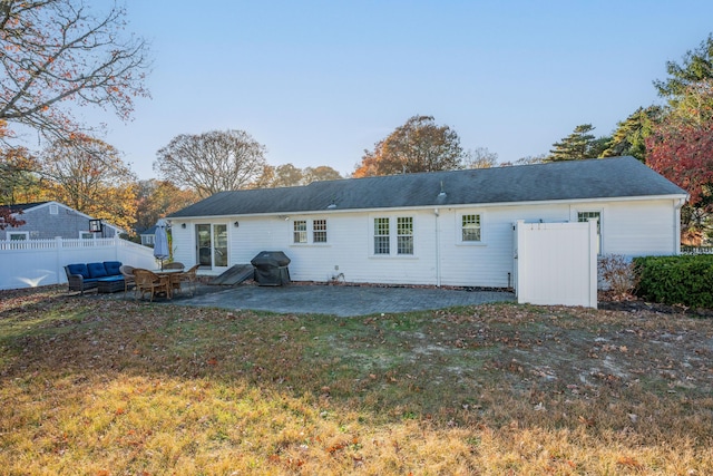 back of house featuring a patio and a yard