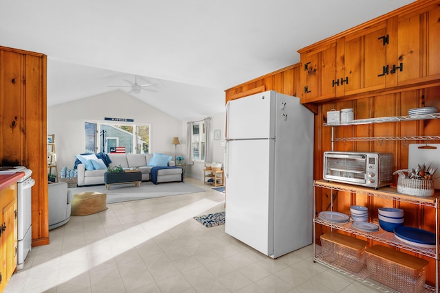 kitchen with ceiling fan, white appliances, and vaulted ceiling