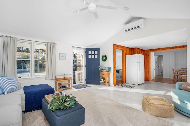 living room featuring lofted ceiling, wood walls, ceiling fan, light tile patterned floors, and a wall mounted air conditioner