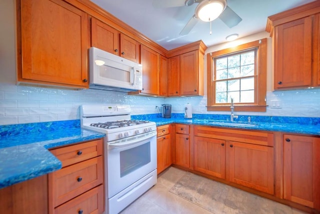 12 Tree Top Ln, East Falmouth, MA 02536 - kitchen with white appliances, backsplash, dark stone countertops, brown cabinets, and a ceiling fan