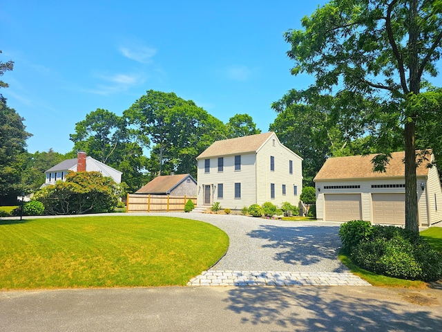 12 Tree Top Ln, East Falmouth, MA 02536 - colonial-style house featuring a front yard, an outdoor structure, a garage, and decorative driveway