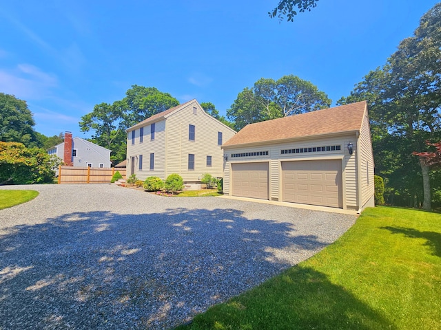 12 Tree Top Ln, East Falmouth, MA 02536 - view of front of home with an outdoor structure and a detached garage