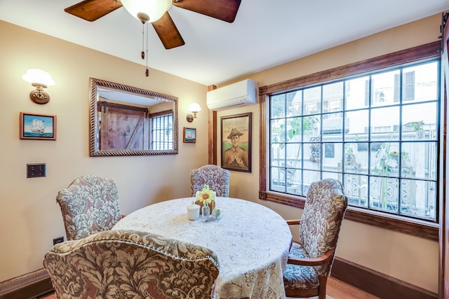 dining room featuring wood-type flooring, a wall mounted air conditioner, a baseboard heating unit, and ceiling fan