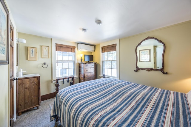 carpeted bedroom featuring multiple windows and a wall unit AC