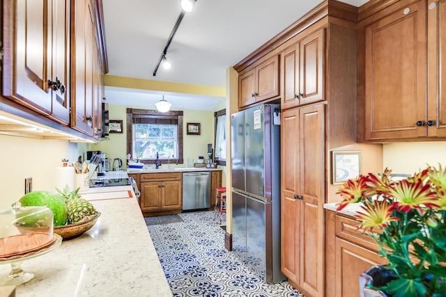 6 Winslow St, Provincetown, MA 02657 - kitchen with light stone counters, sink, stainless steel appliances, and rail lighting