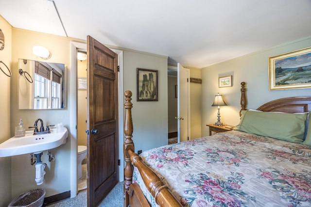 bedroom featuring sink and carpet