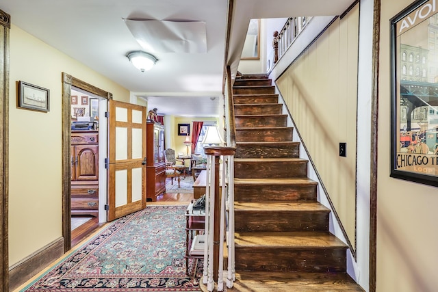 stairs with hardwood / wood-style floors