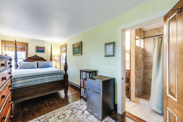 bedroom with crown molding, hardwood / wood-style floors, and stainless steel refrigerator